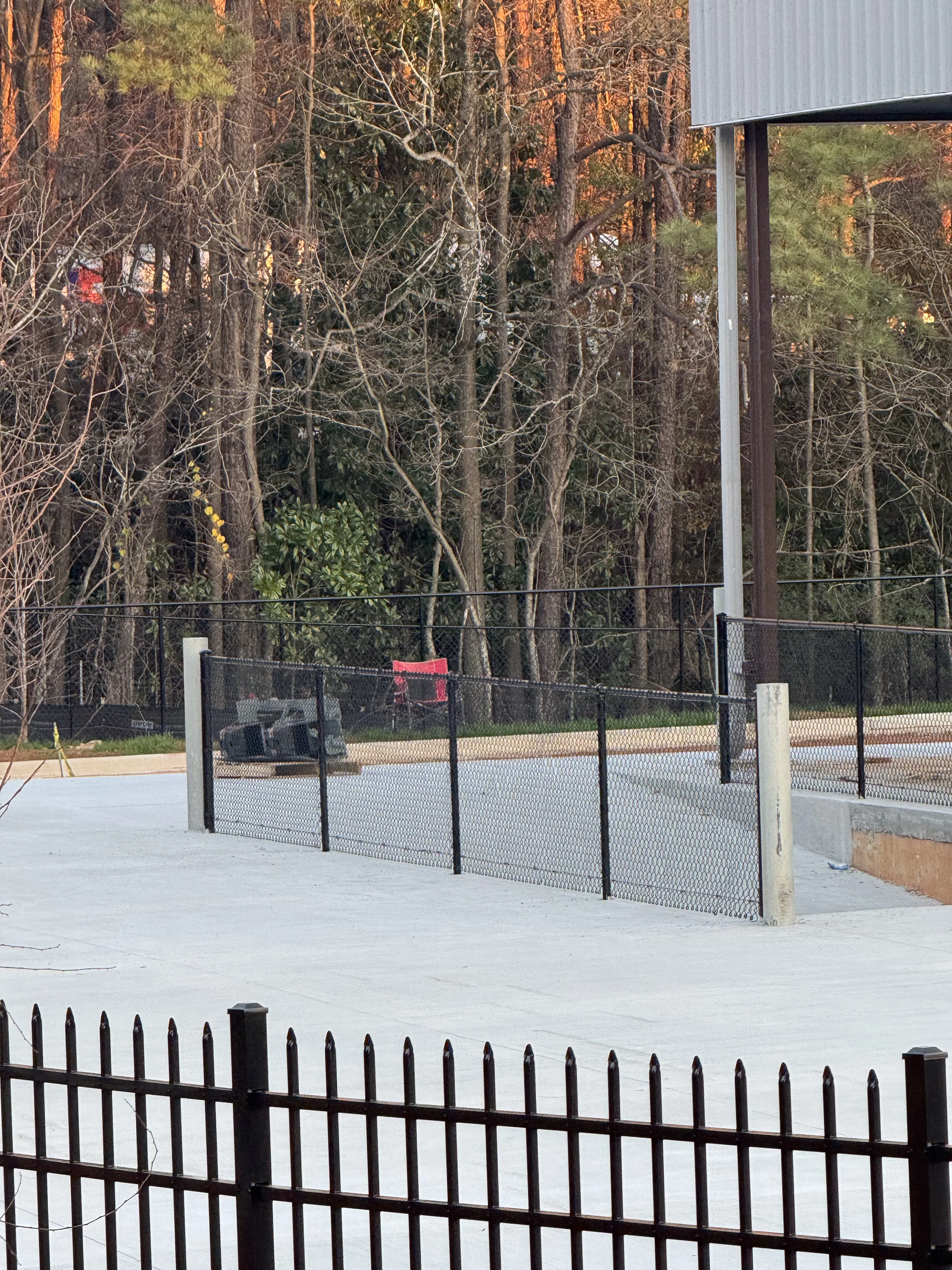 Iron fence with mesh panels along driveway