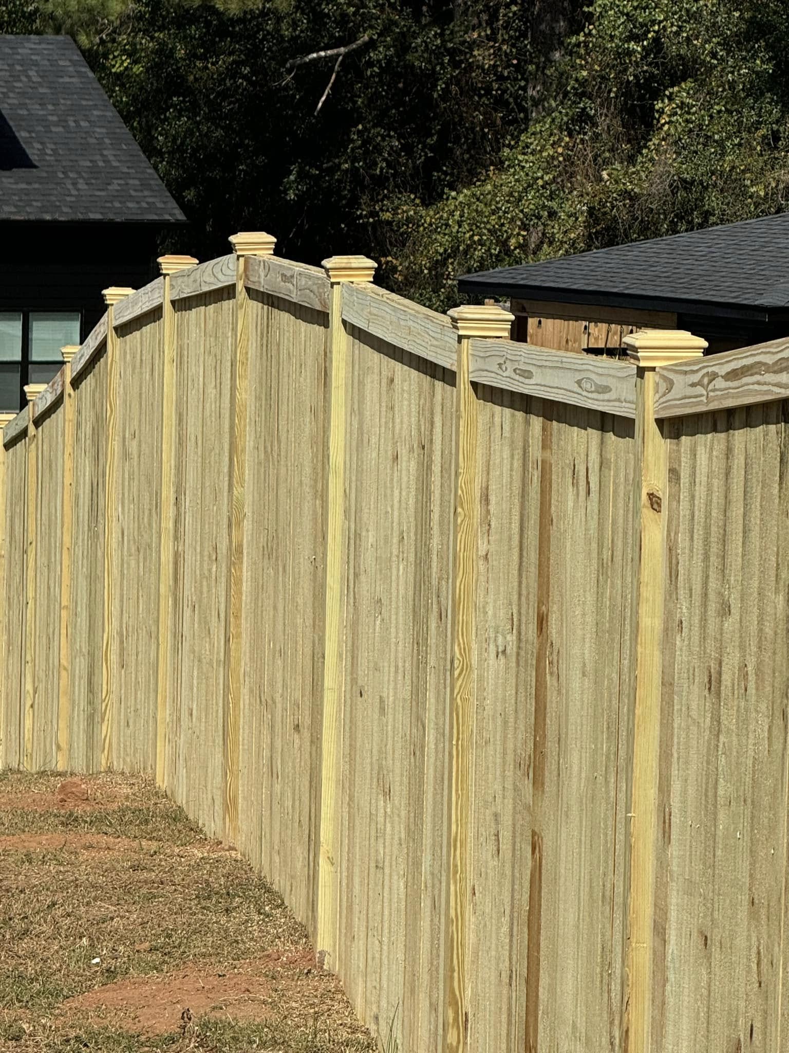 Wood privacy fence with decorative post caps