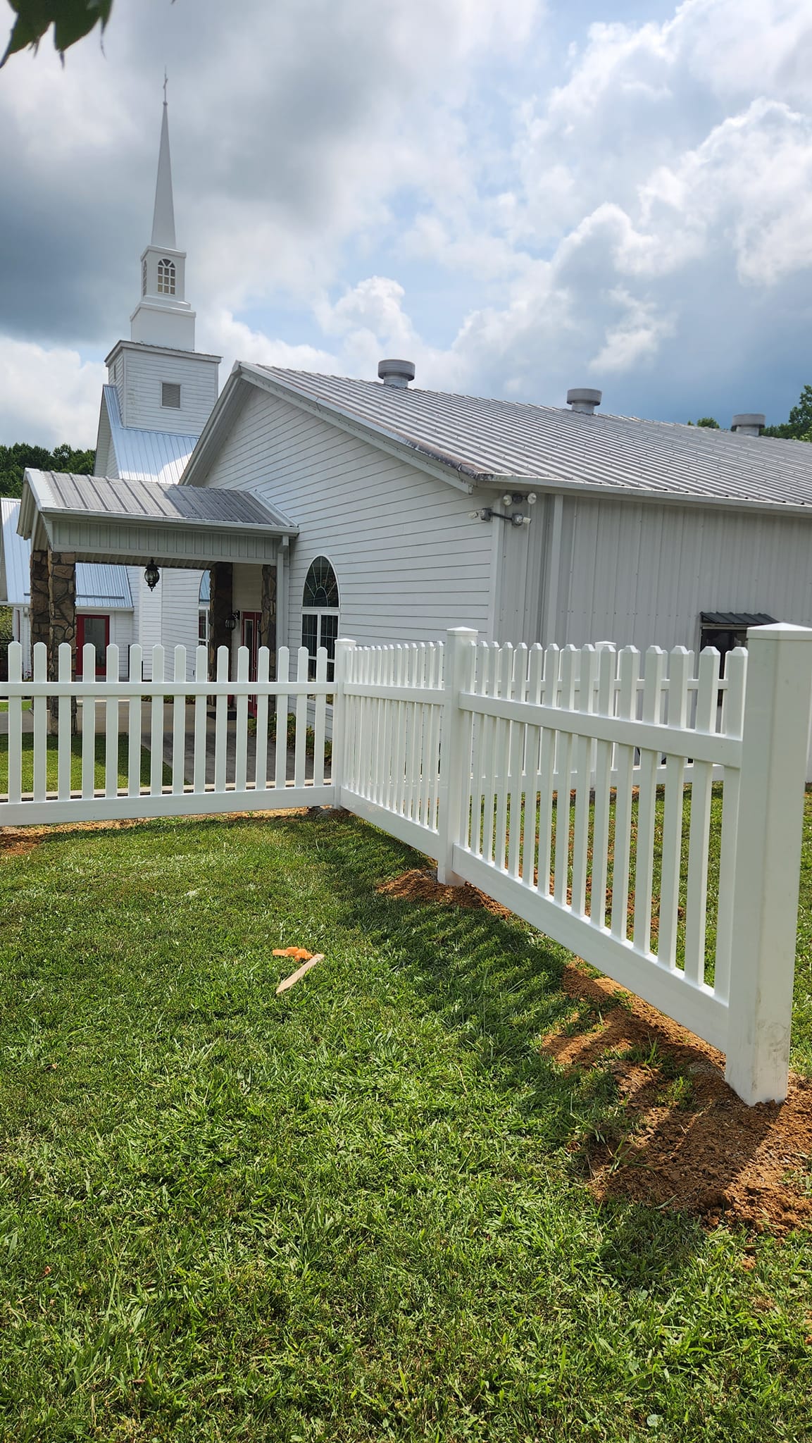 White vinyl picket fence at church
