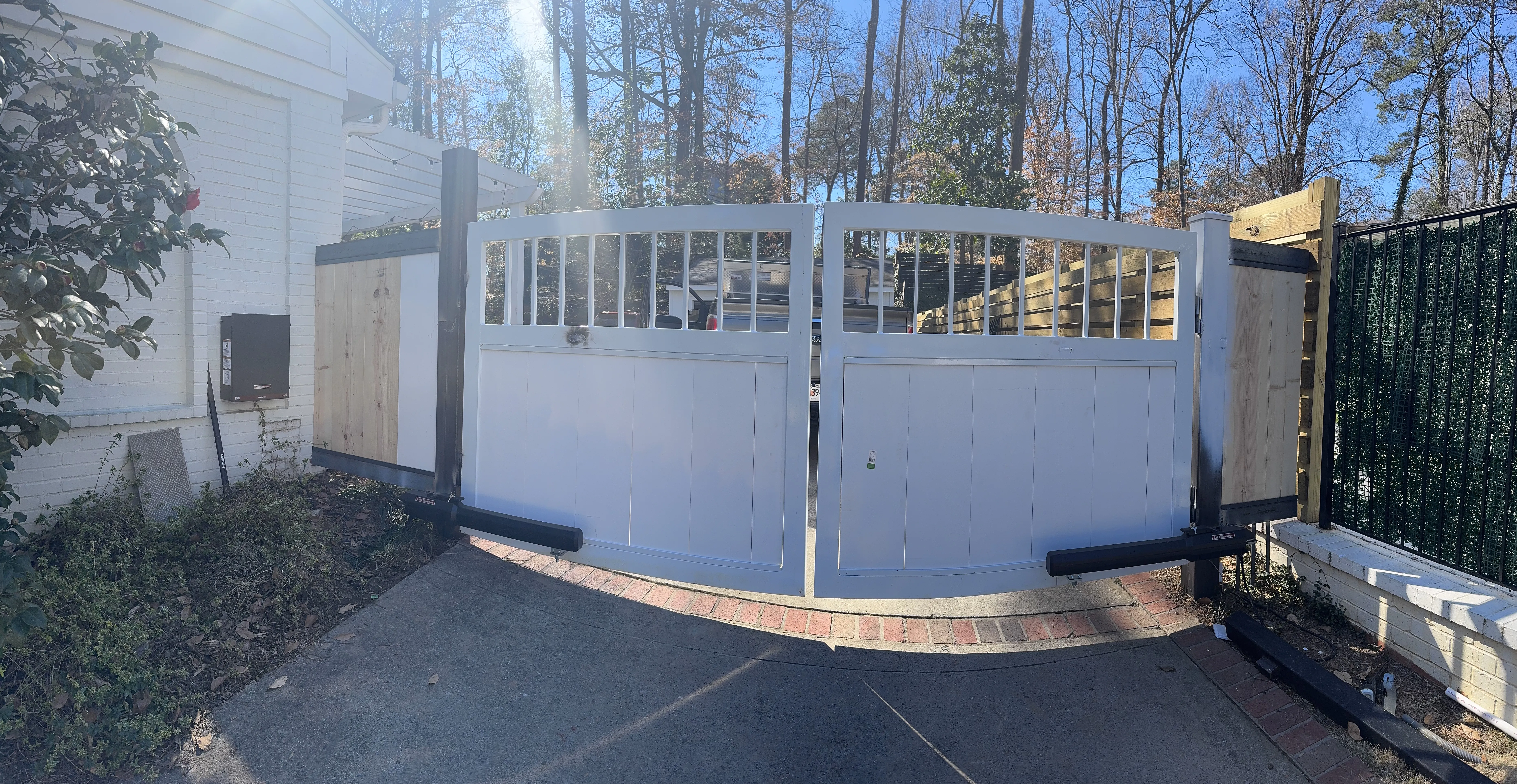 White custom driveway gate with window panels