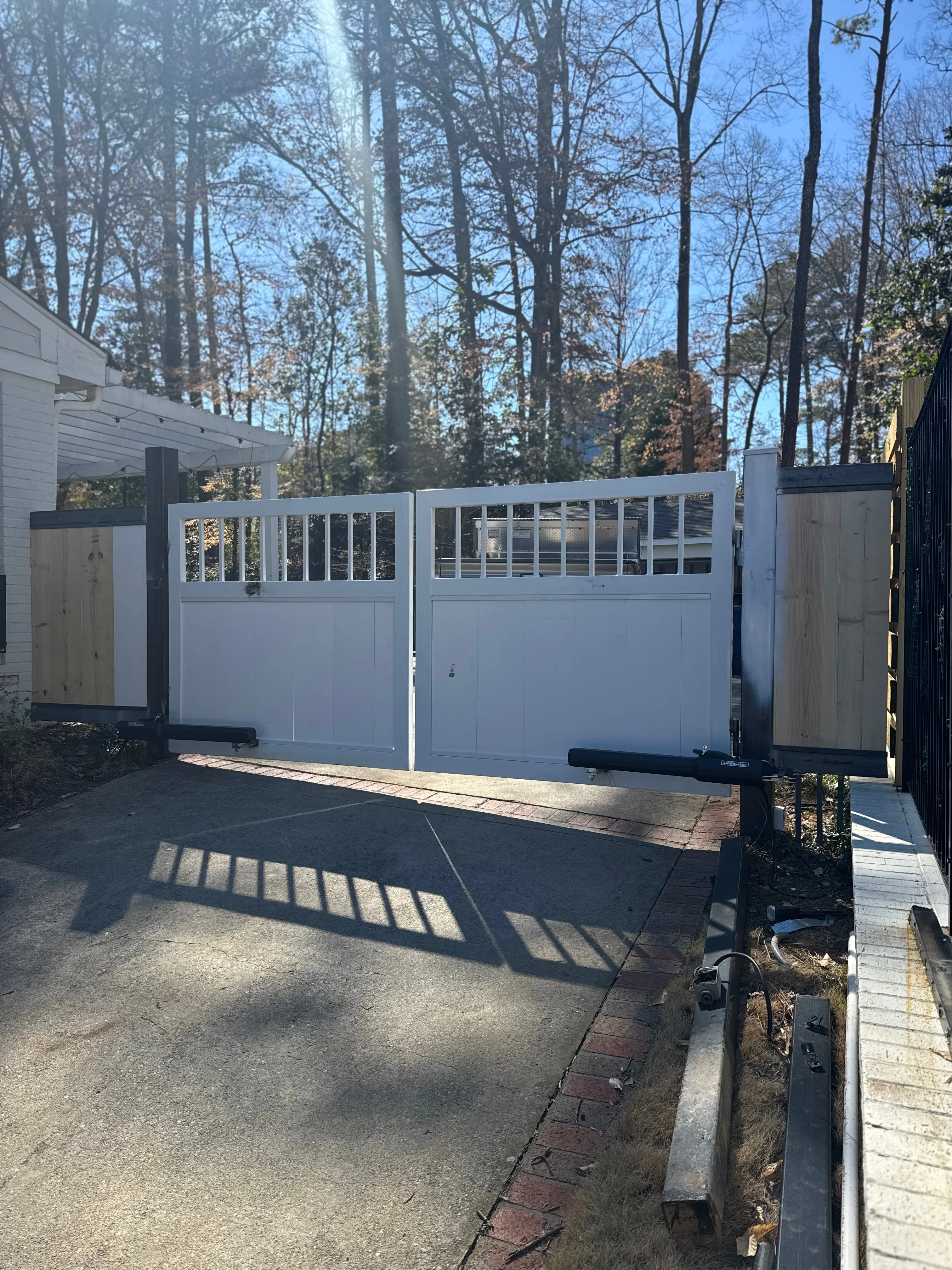 White custom driveway gate detail view